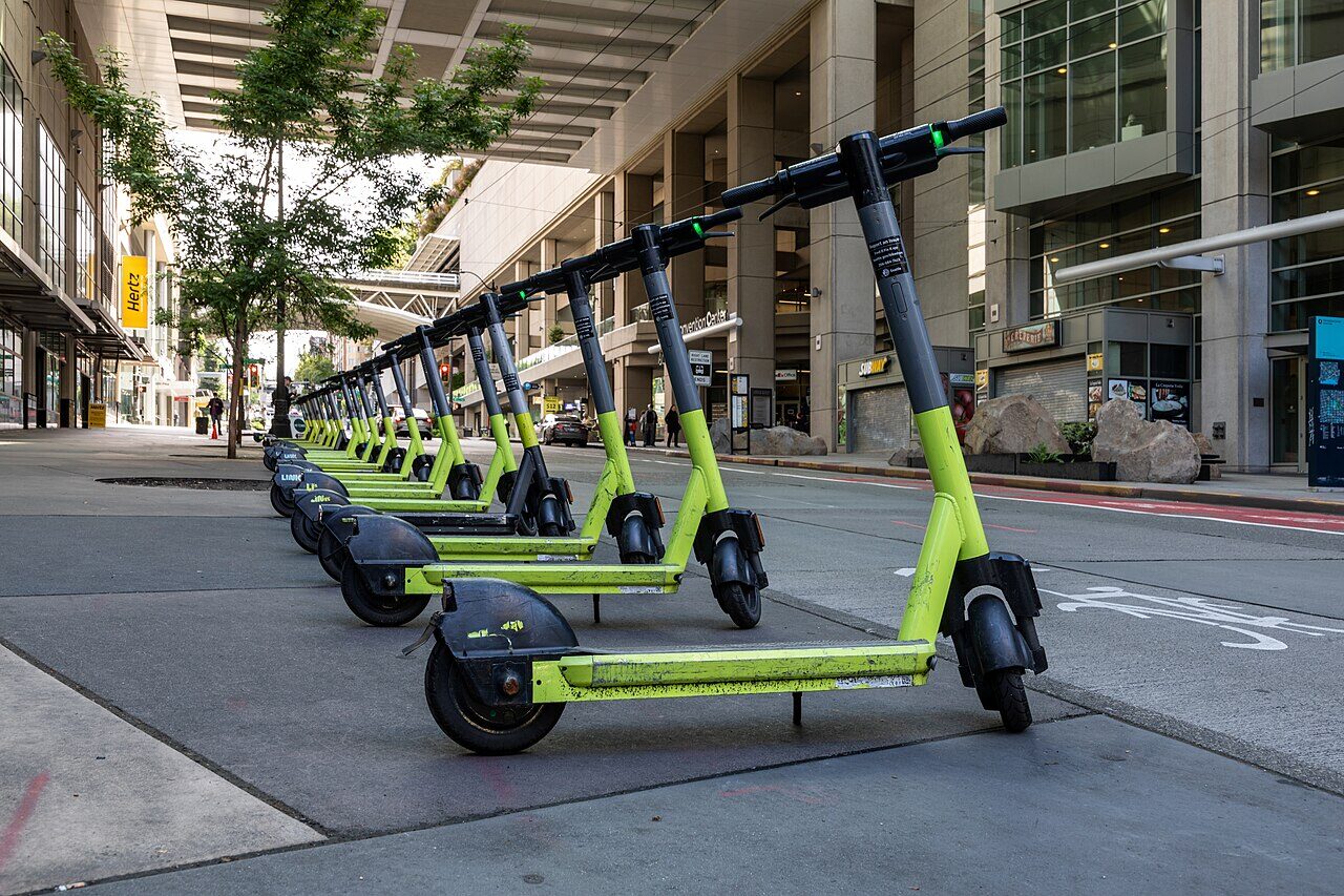 An electric kick-scooter parked on a city street — representative file photo