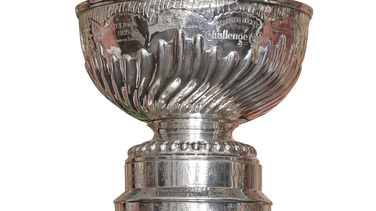 Close-up photo of the engraved silver Stanley Cup trophy.
