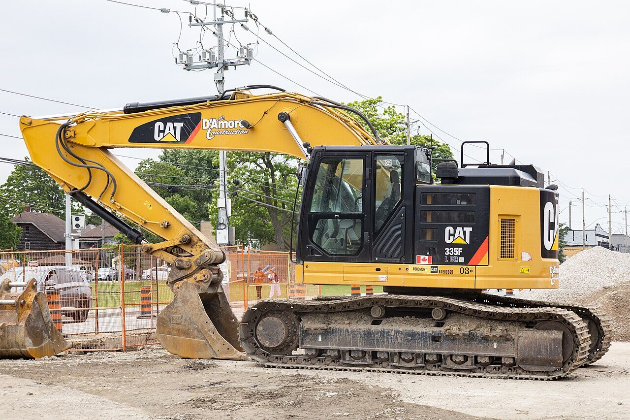 Road construction crew and equipment resurfacing a city street in Ontario.
